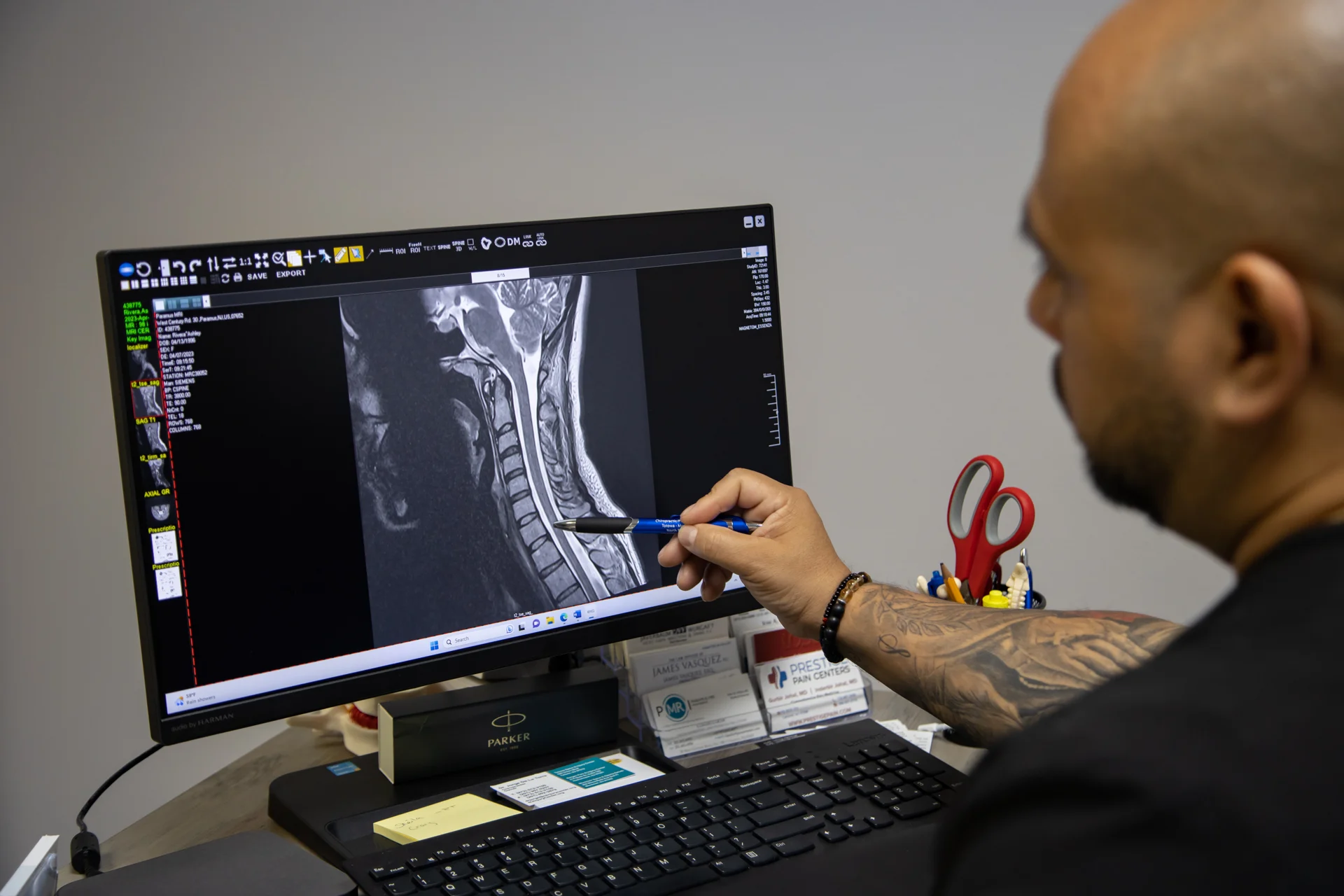 A clinician reviewing a spinal X-ray at the clinic