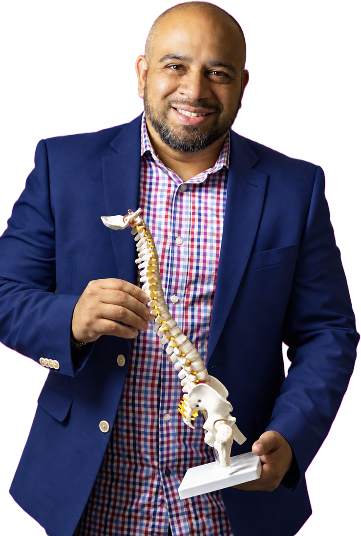 Dr. Jorge De La Torre holding a spine model